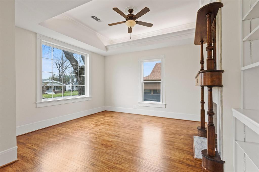 1001 West Morton Street Denison, TX 75020 - Photo 10 of 37 a view of an empty room with a window and wooden floor