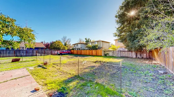 a view of a swimming pool with a patio and a yard
