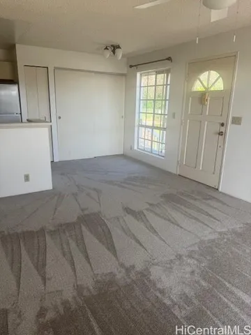a view of an empty room with windows and cabinet