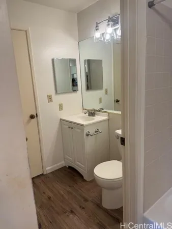 a bathroom with a toilet a sink and mirror