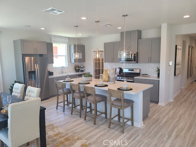 a large kitchen with a table and chairs