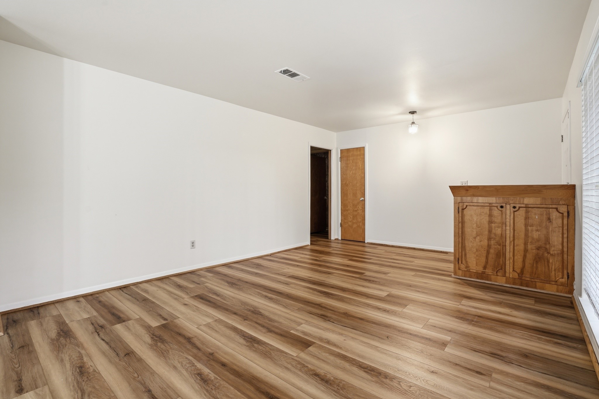 10240 Post Oak Drive Conroe, TX 77385 - Photo 11 of 46 a view of an empty room with wooden floor and a window