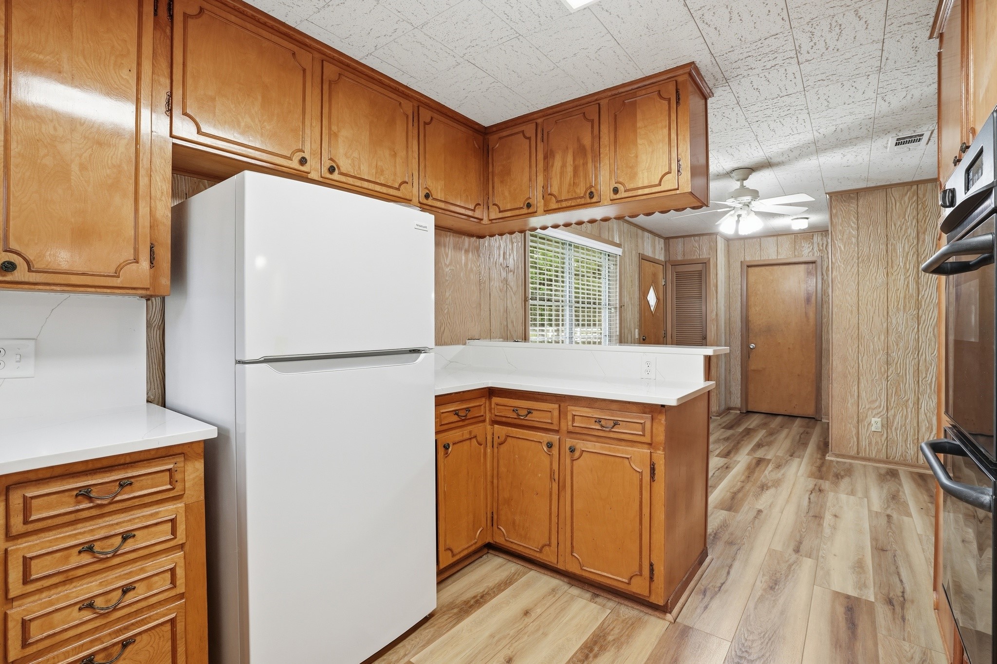 10240 Post Oak Drive Conroe, TX 77385 - Photo 18 of 46 a kitchen with stainless steel appliances granite countertop a refrigerator a oven and white cabinets with wooden floors