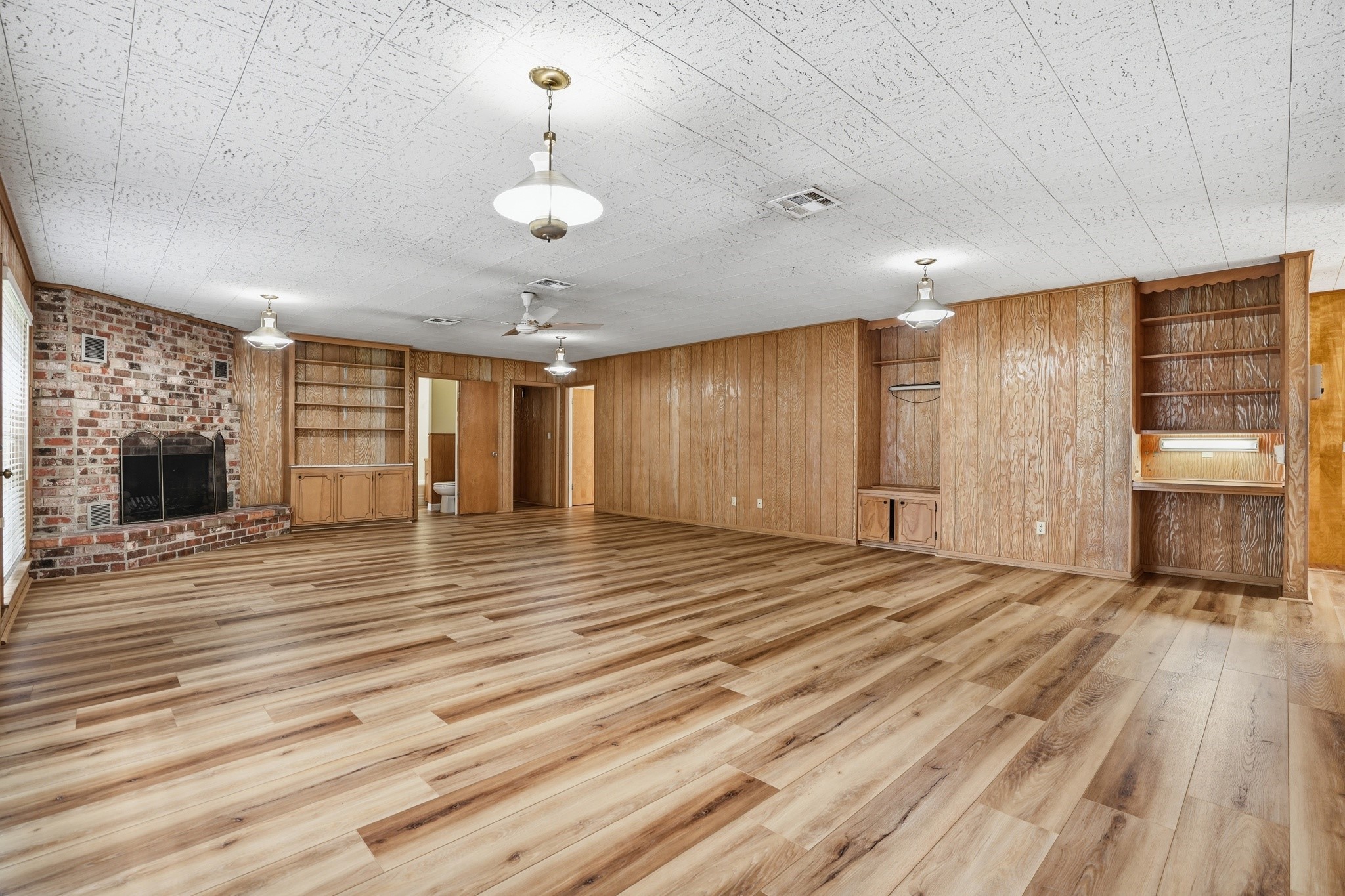 10240 Post Oak Drive Conroe, TX 77385 - Photo 22 of 46 a view of an empty room with window and wooden floor