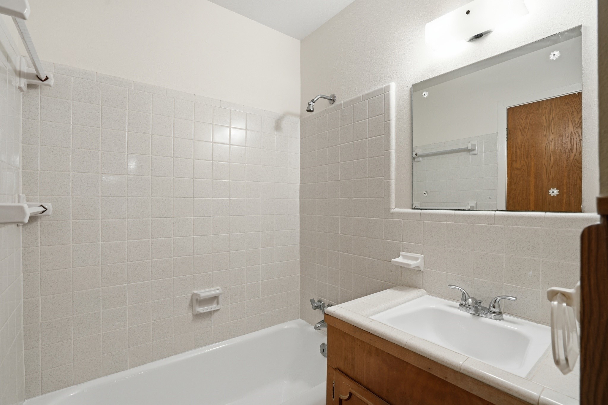 10240 Post Oak Drive Conroe, TX 77385 - Photo 25 of 46 a bathroom with a sink a shower and a mirror