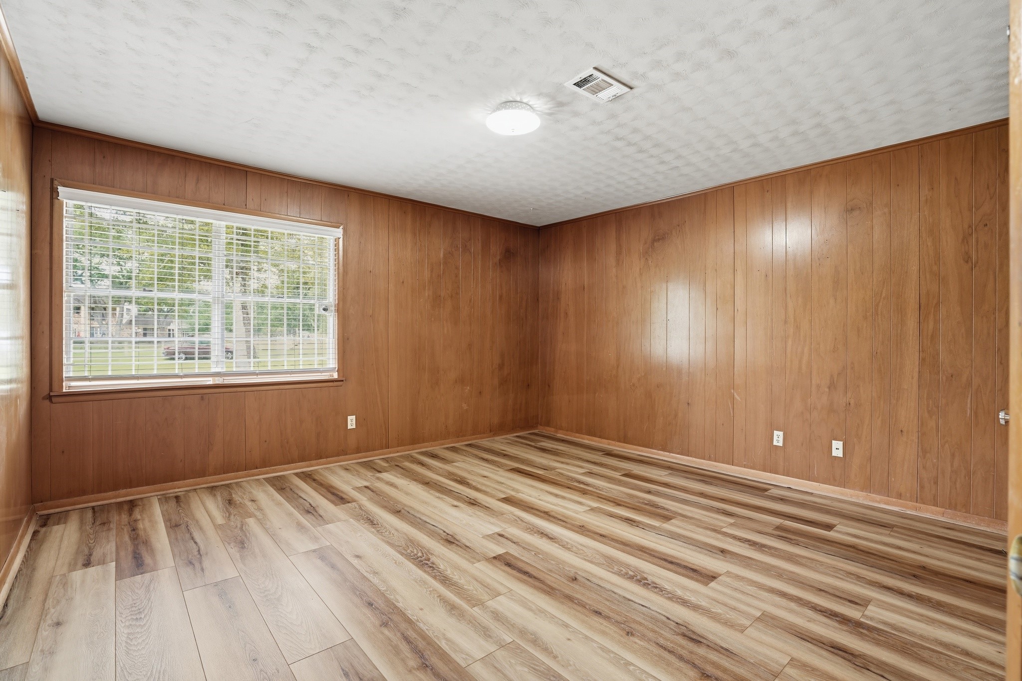 10240 Post Oak Drive Conroe, TX 77385 - Photo 27 of 46 a view of an empty room with wooden floor and a window