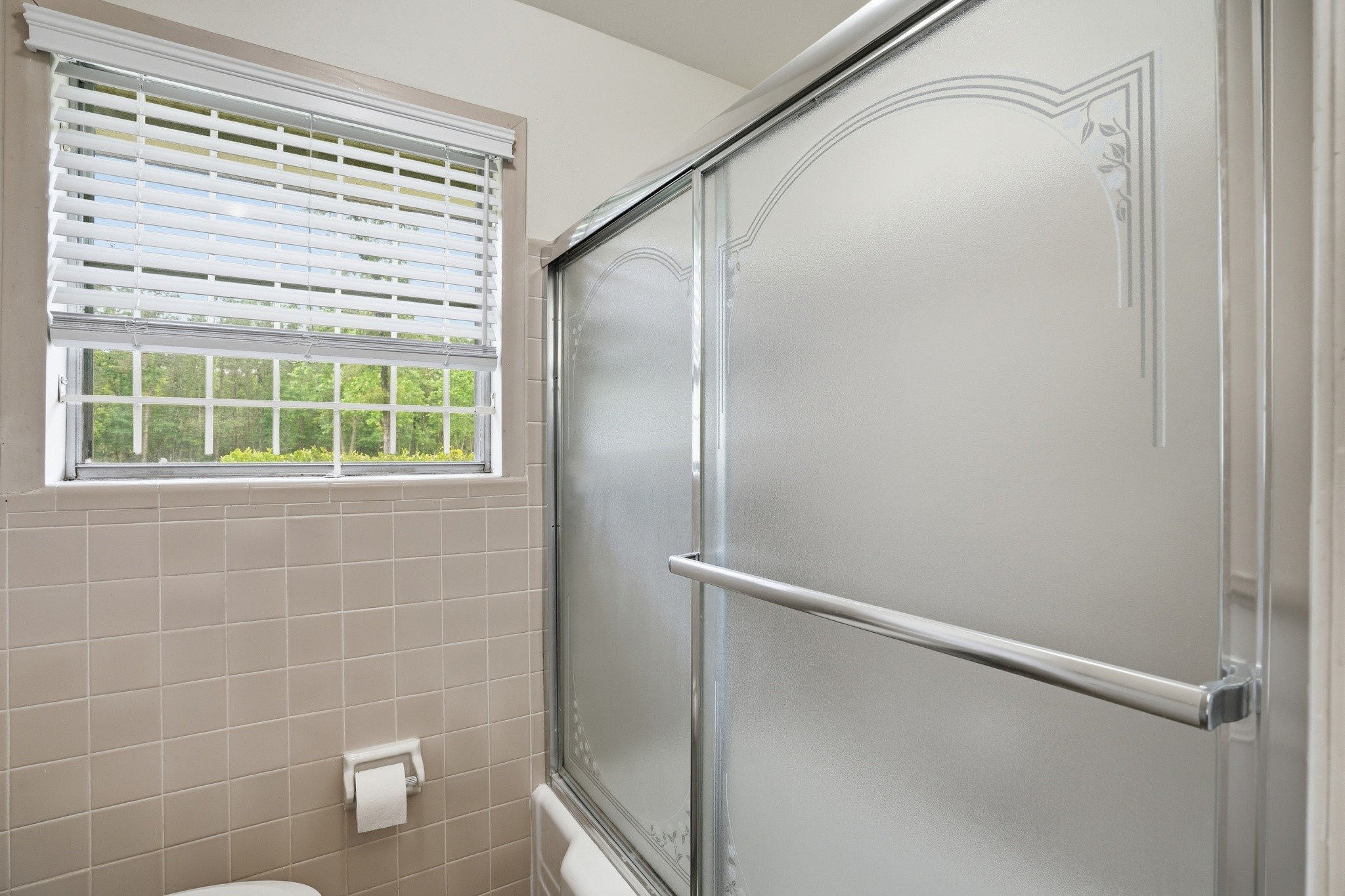 10240 Post Oak Drive Conroe, TX 77385 - Photo 32 of 46 a bathroom with a window and a shower