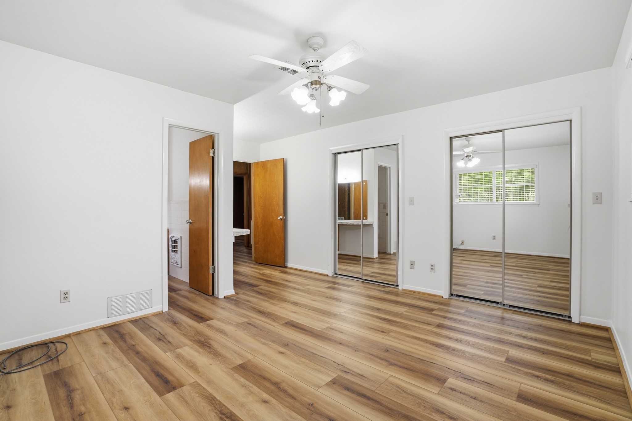 10240 Post Oak Drive Conroe, TX 77385 - Photo 35 of 46 a view of an empty room with wooden floor and a ceiling fan