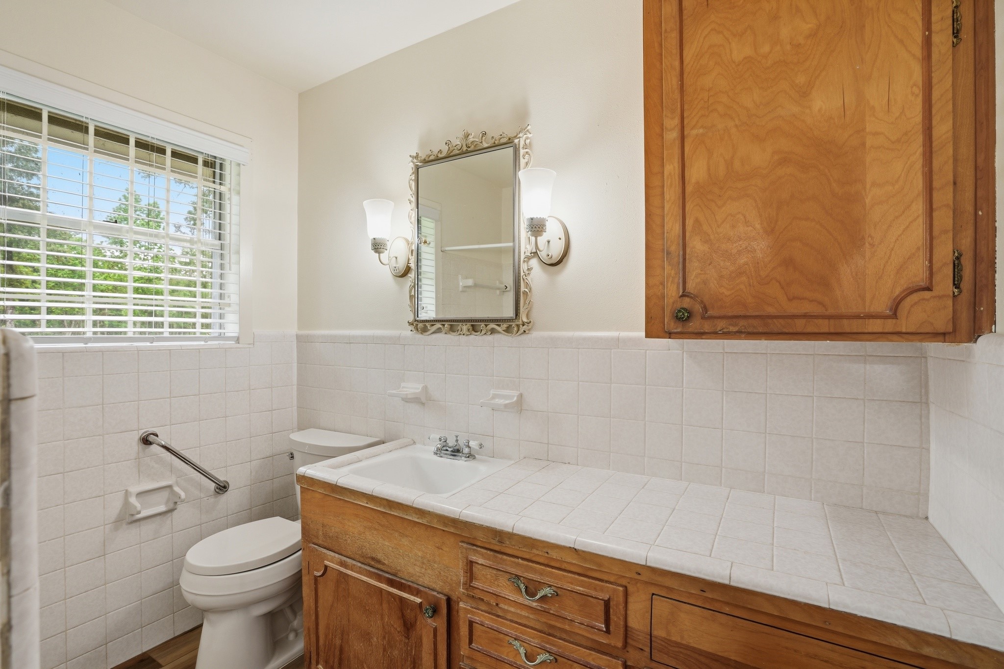 10240 Post Oak Drive Conroe, TX 77385 - Photo 36 of 46 a bathroom with a sink a toilet and mirror
