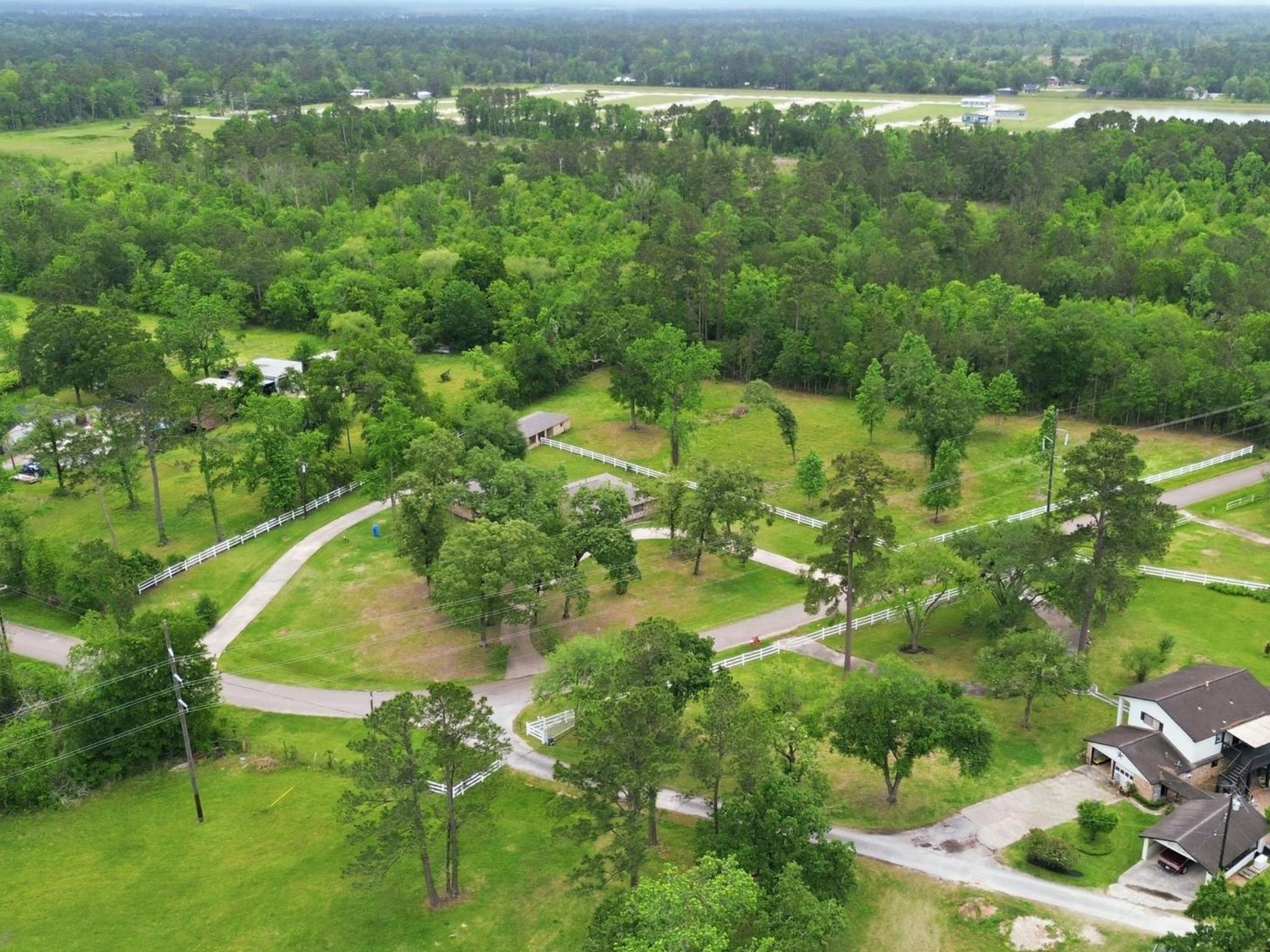 10240 Post Oak Drive Conroe, TX 77385 - Photo 45 of 46 an aerial view of residential houses with outdoor space and trees