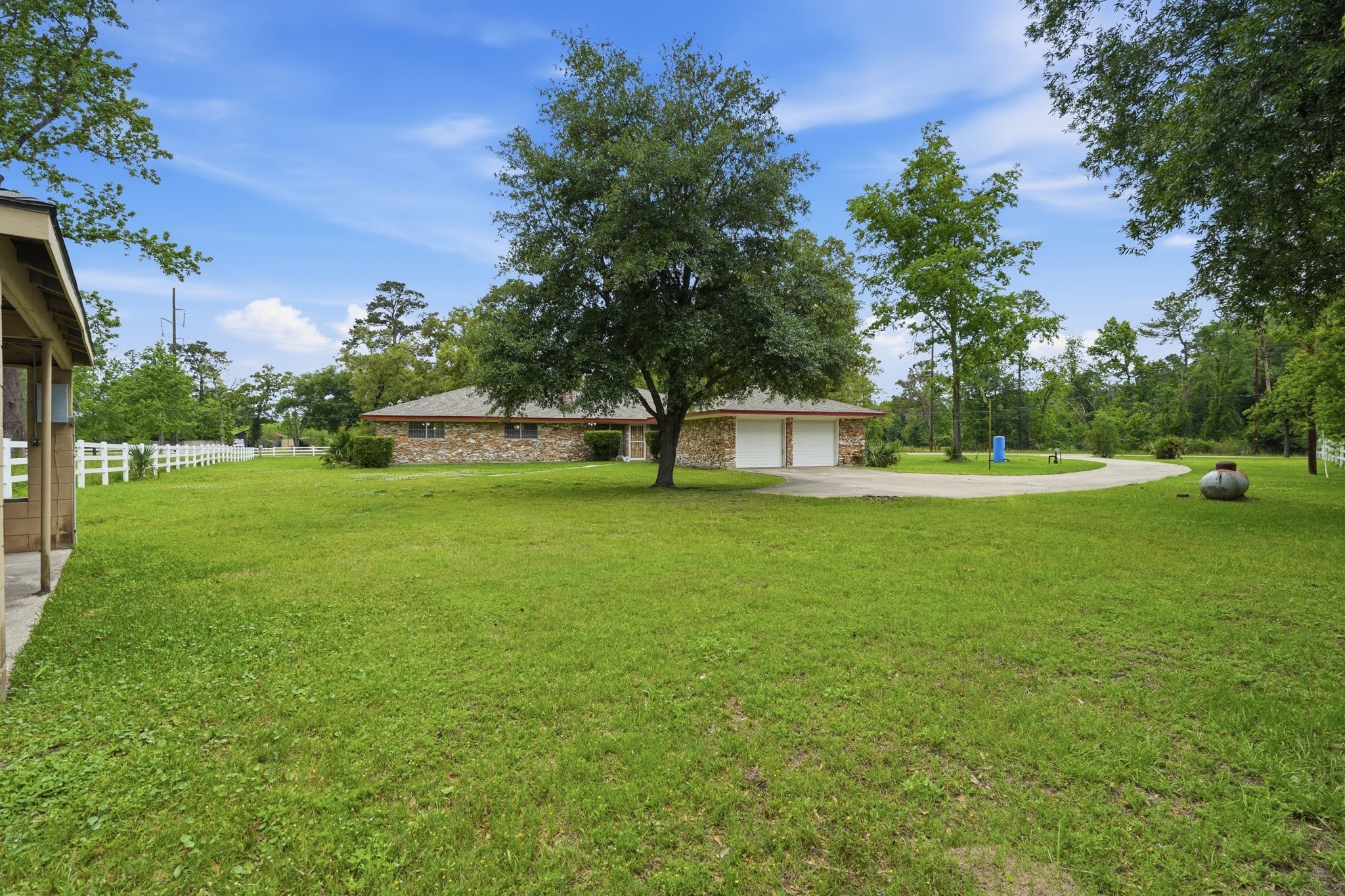 10240 Post Oak Drive Conroe, TX 77385 - Photo 6 of 46 a view of green field with tree in the background