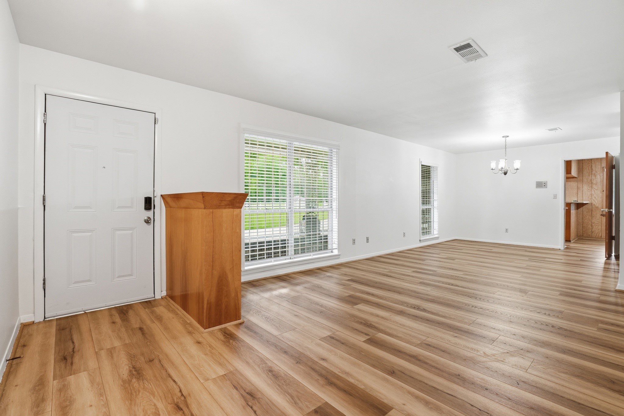 10240 Post Oak Drive Conroe, TX 77385 - Photo 9 of 46 a view of a room with wooden floor and a cabinet