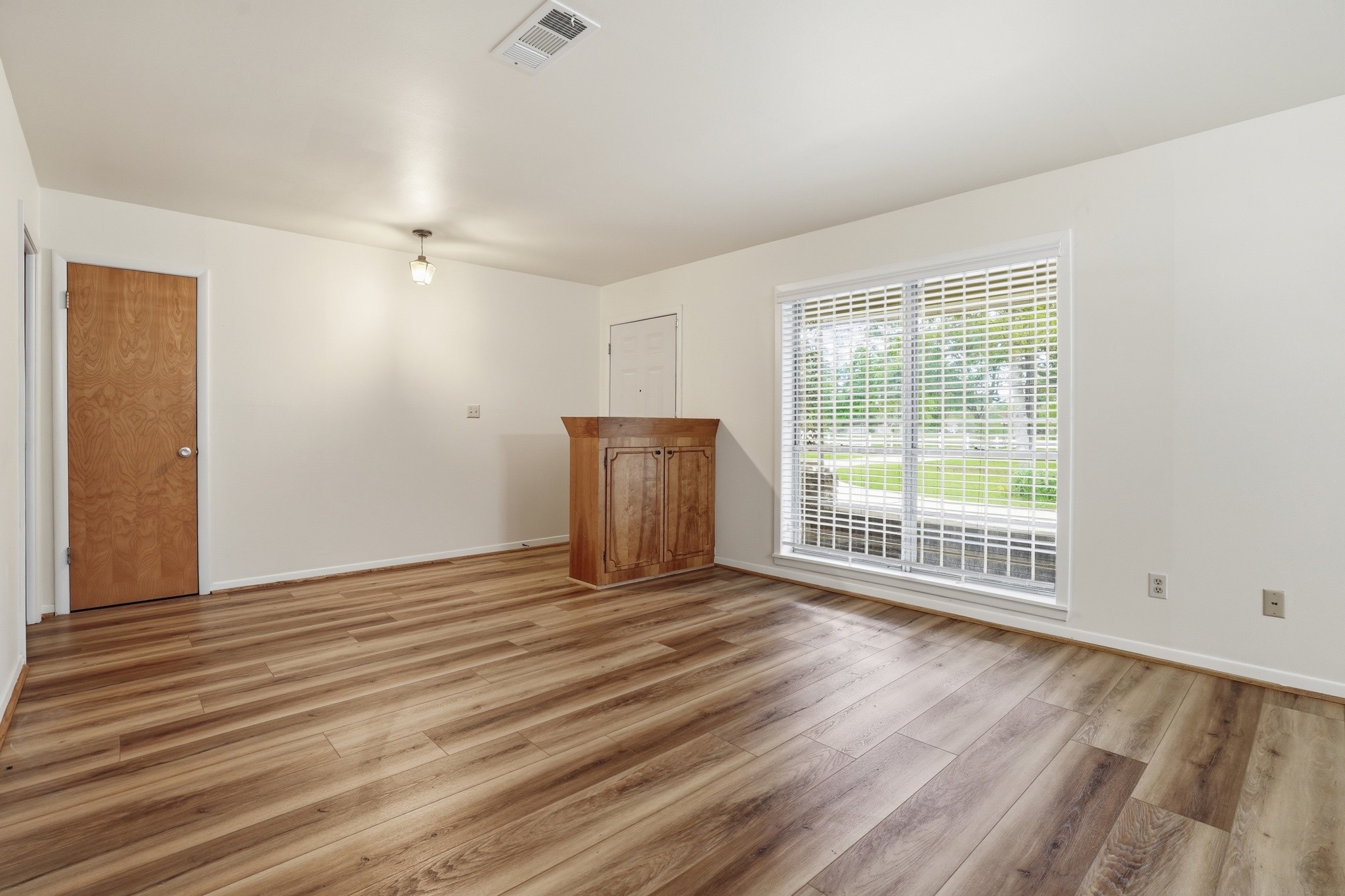 10240 Post Oak Drive Conroe, TX 77385 - Photo 10 of 46 a view of an empty room with wooden floor and a window