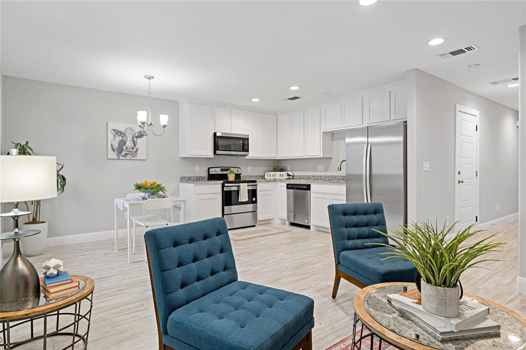 Living area featuring recessed lighting, a chandelier, and light wood-type flooring