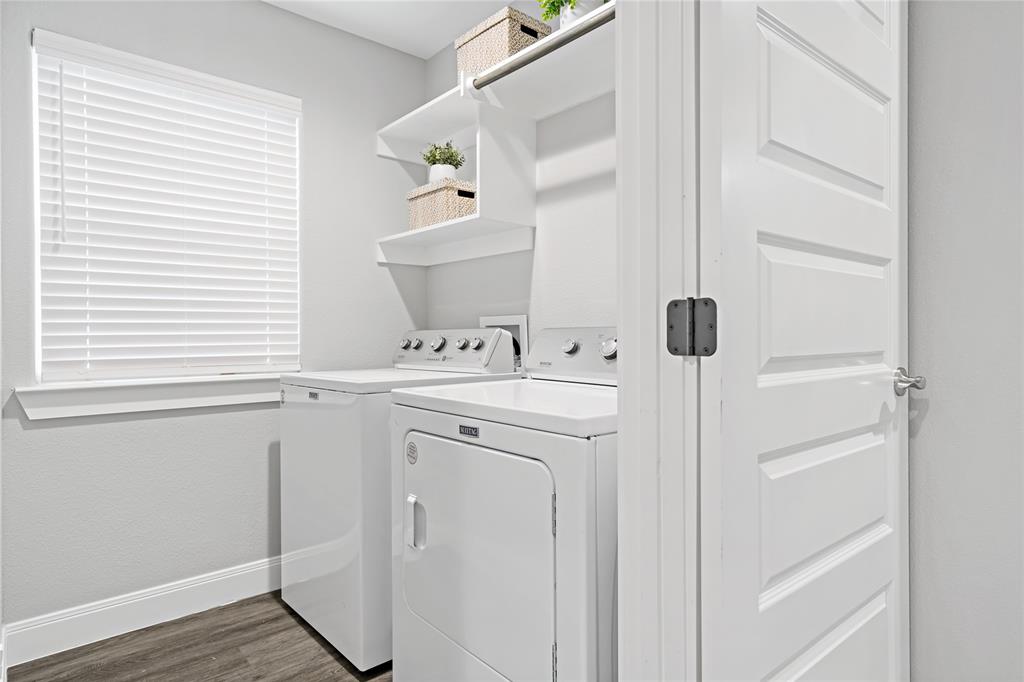 526 West Elm Street Denison, TX 75020 - Photo 17 of 17 Laundry area with dark wood-type flooring and washer and dryer