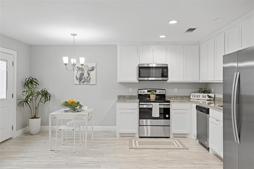 526 West Elm Street Denison, TX 75020 - Photo 4 of 17 Kitchen featuring stainless steel appliances, white cabinetry, hanging light fixtures, and recessed lighting