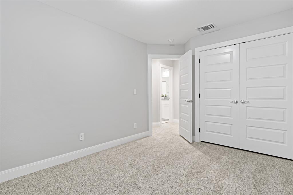 526 West Elm Street Denison, TX 75020 - Photo 9 of 17 Unfurnished bedroom featuring light carpet and a closet