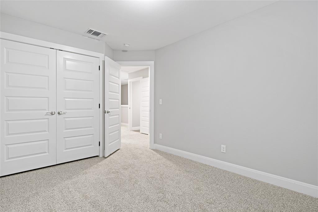 526 West Elm Street Denison, TX 75020 - Photo 10 of 17 Unfurnished bedroom with light carpet and a closet