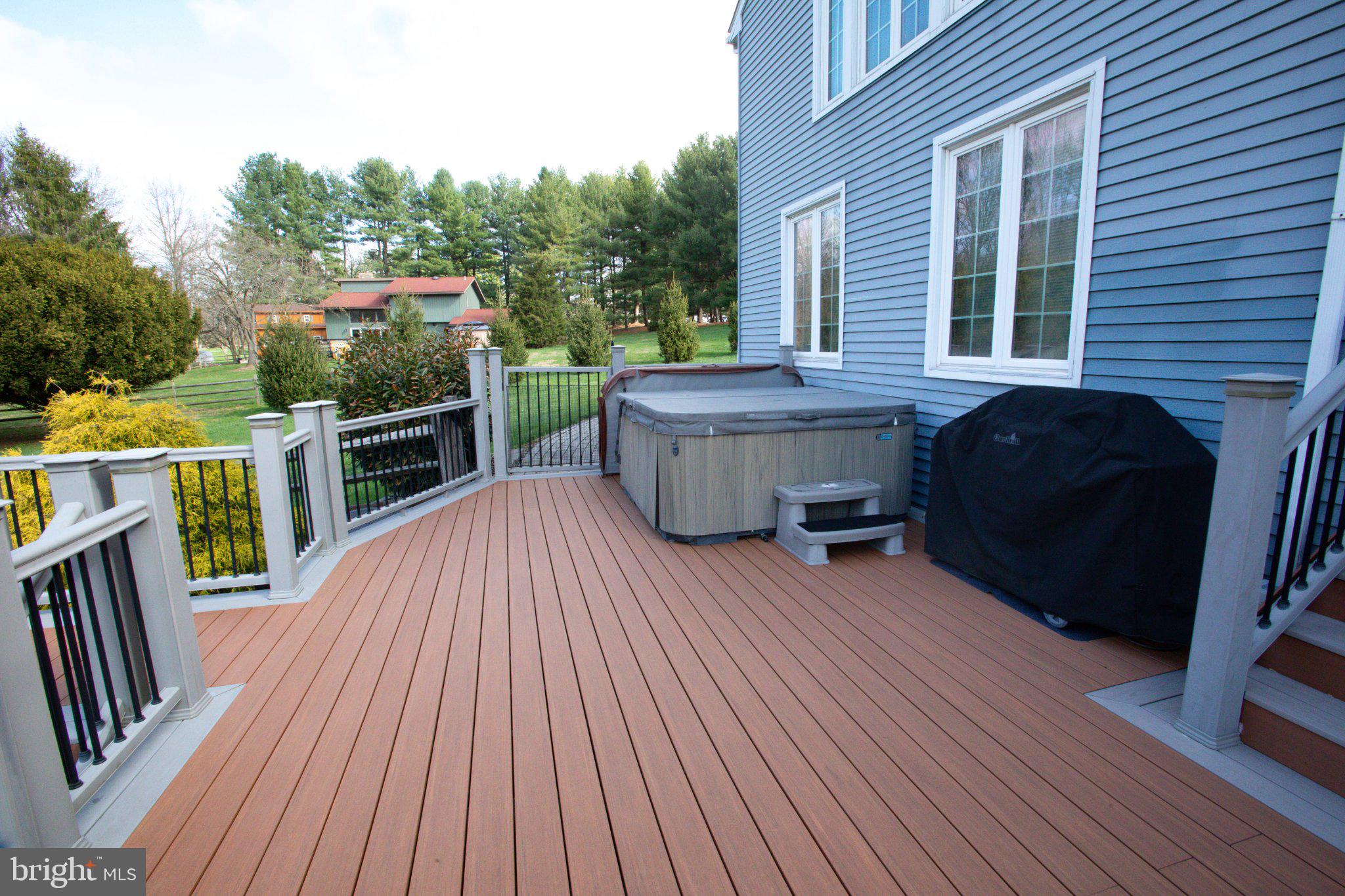42 Eleanor Drive Spring City, PA 19475 - Photo 11 of 59 a view of deck with table and chairs a barbeque with wooden floor and fence