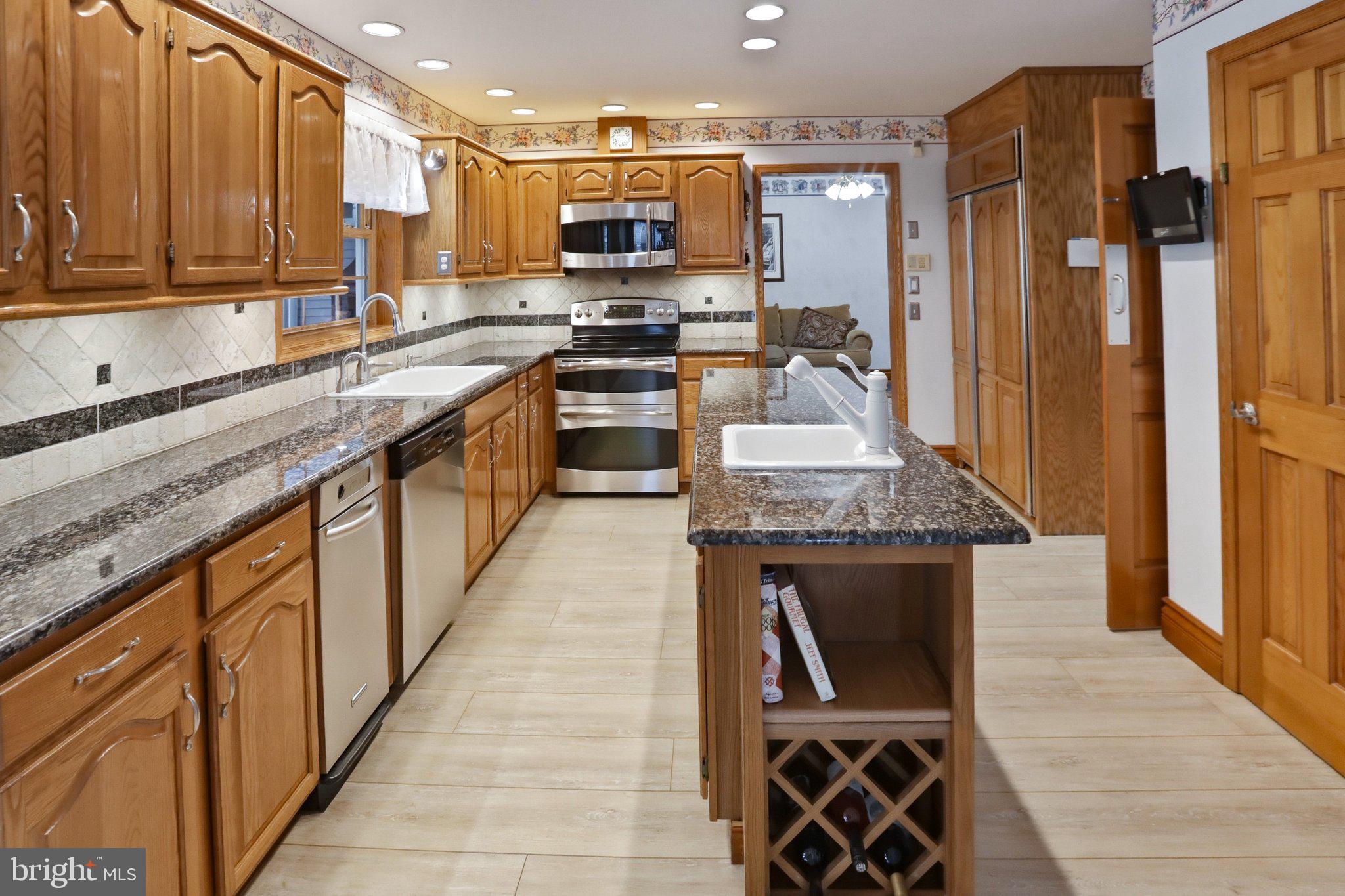 42 Eleanor Drive Spring City, PA 19475 - Photo 27 of 59 a kitchen with stainless steel appliances granite countertop a stove a sink and a microwave