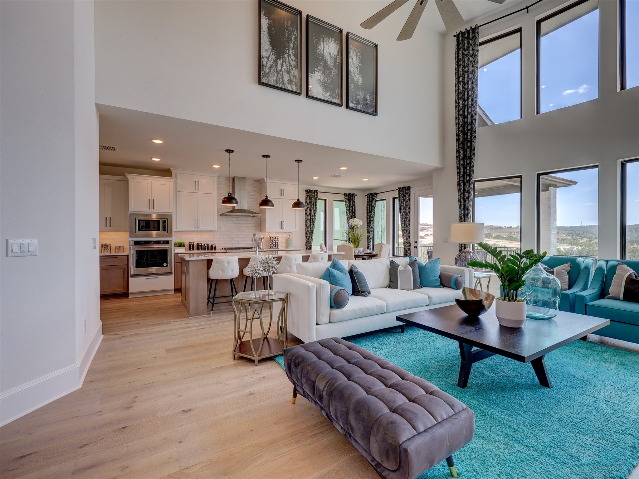 6220 Bower Well Road Austin, TX 78738 - Photo 8 of 28 An open concept living area blends a well-appointed kitchen with an airy living room, all beneath soaring ceilings and bathed in natural light.