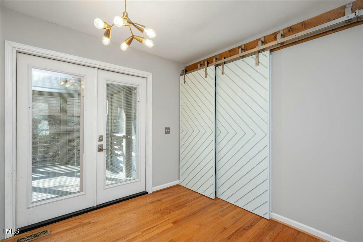552 Moseley Lane Raleigh, NC 27601 - Photo 11 of 25 a view of an empty room with wooden floor and a window