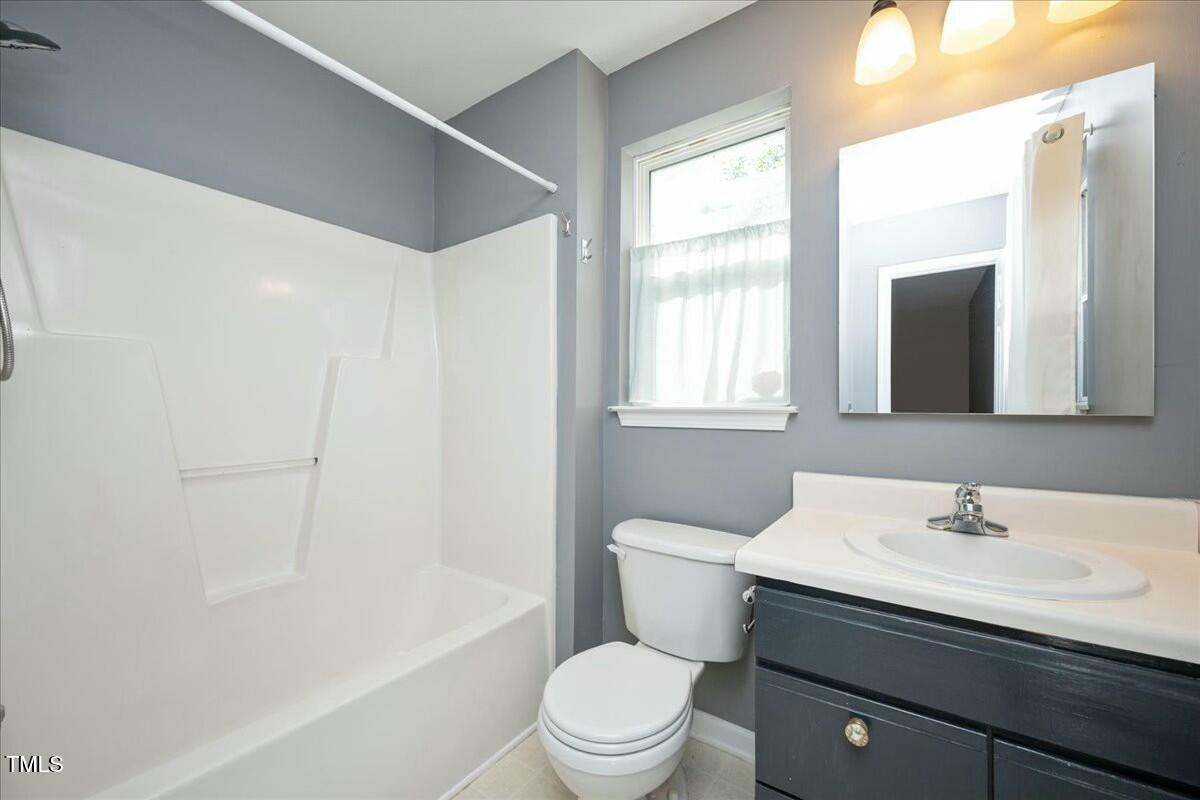 552 Moseley Lane Raleigh, NC 27601 - Photo 21 of 25 a bathroom with a sink a toilet a mirror and a tub