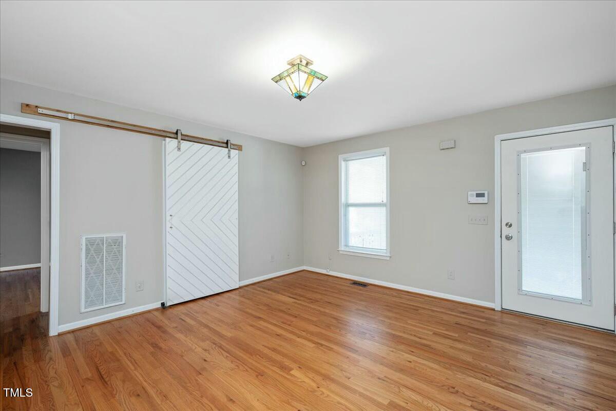 552 Moseley Lane Raleigh, NC 27601 - Photo 7 of 25 a view of empty room with wooden floor and fan