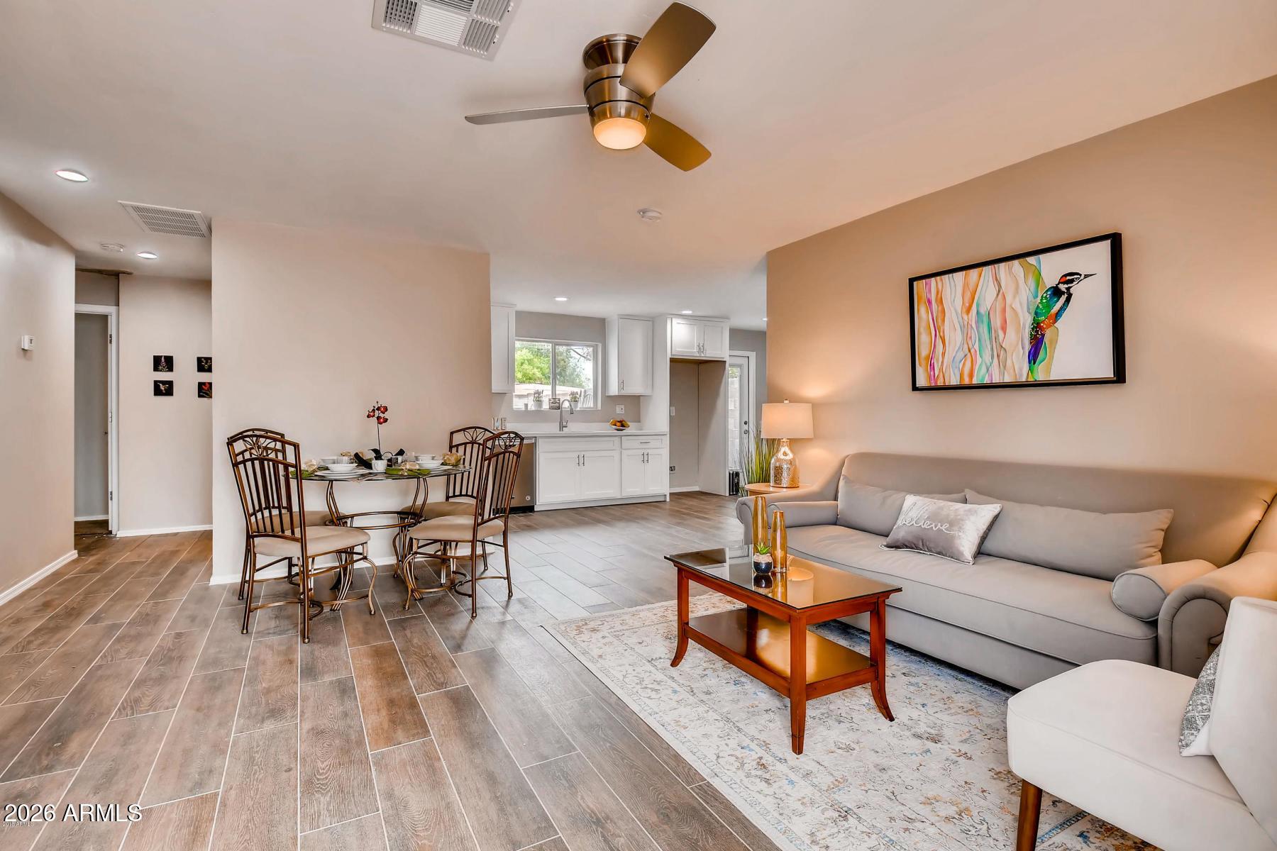 1806 East Don Carlos Tempe, AZ 85281 - Photo 1 of 14 a living room with furniture kitchen view and a wooden floor