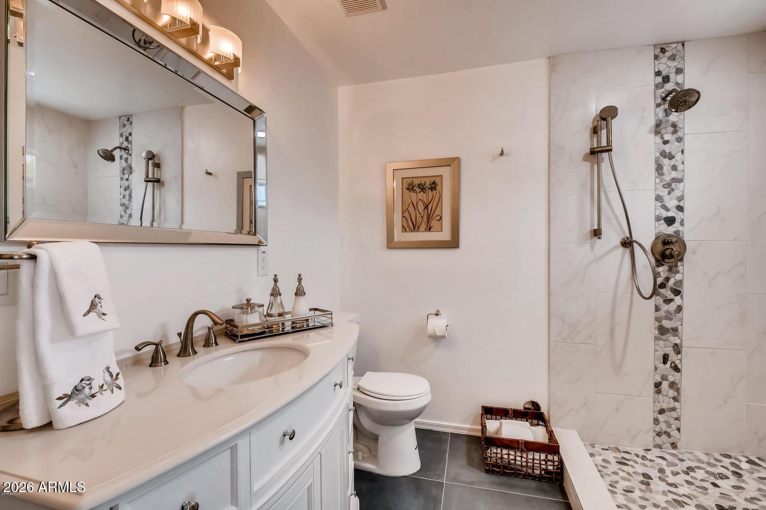 1806 East Don Carlos Tempe, AZ 85281 - Photo 12 of 14 a bathroom with a granite countertop sink mirror vanity and toilet