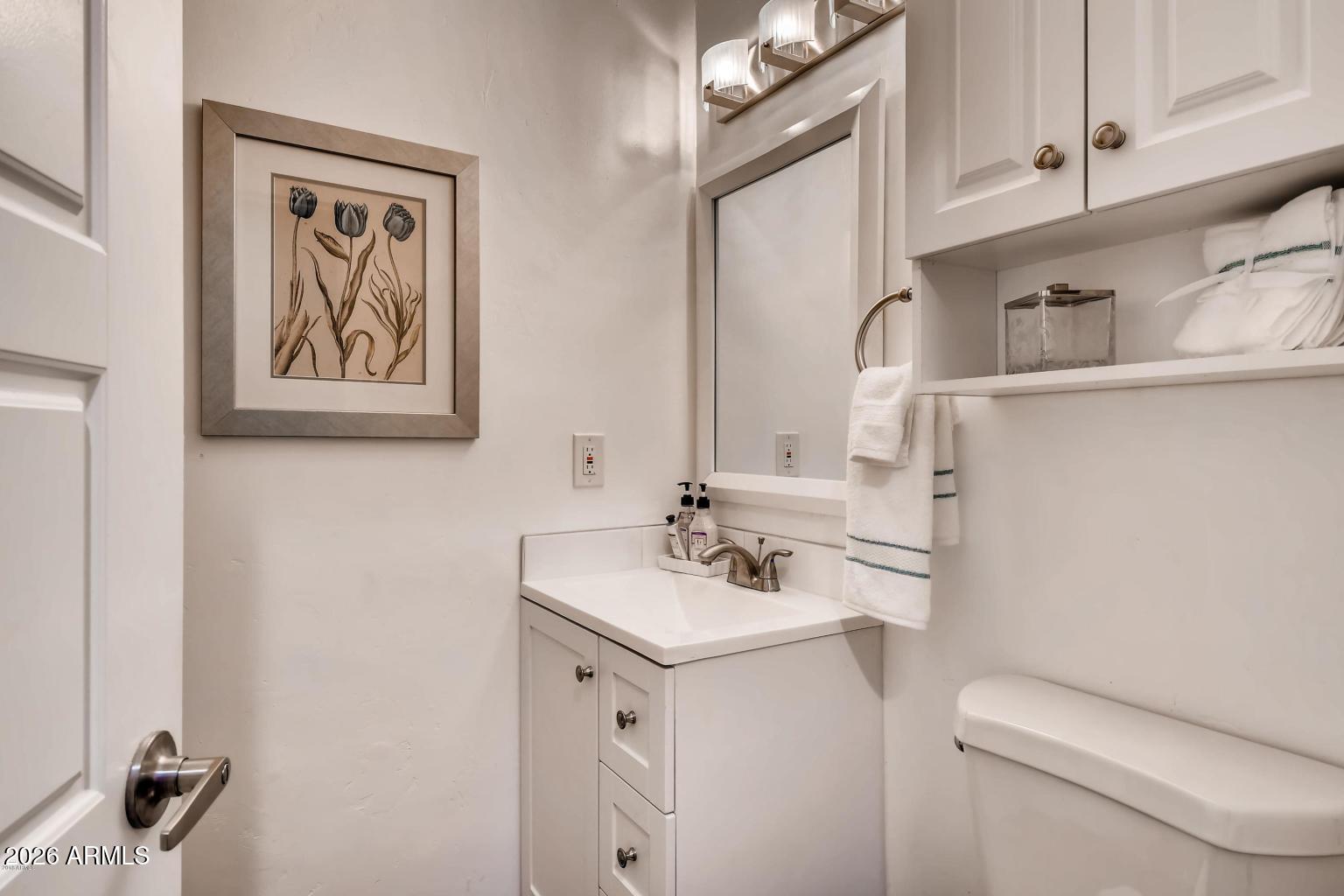 1806 East Don Carlos Tempe, AZ 85281 - Photo 9 of 14 a bathroom with a sink toilet and a mirror