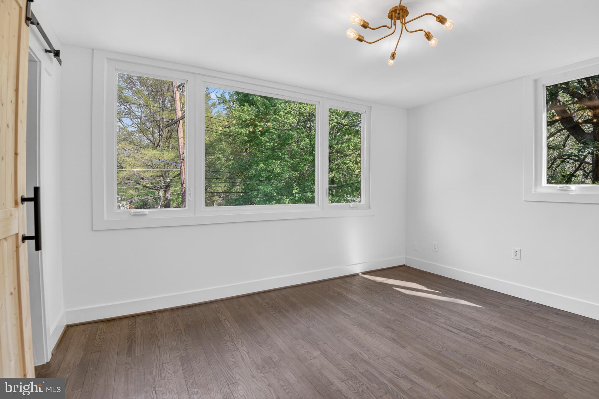 4416 Reno Road Northwest Washington, DC 20008 - Photo 15 of 39 a view of a livingroom with wooden floor and a window