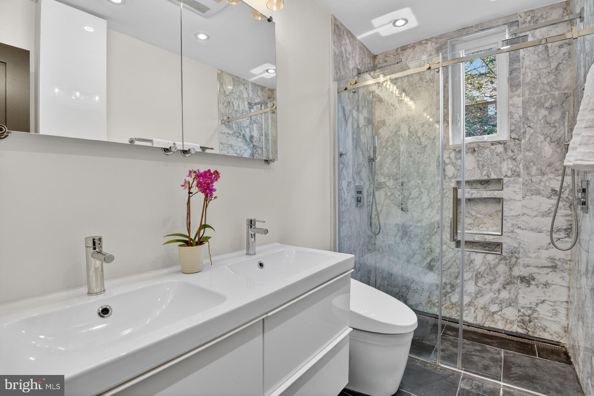 4416 Reno Road Northwest Washington, DC 20008 - Photo 17 of 39 a bathroom with a sink toilet and shower