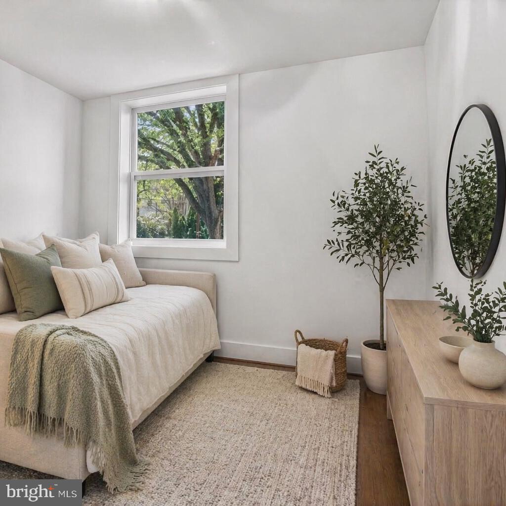 4416 Reno Road Northwest Washington, DC 20008 - Photo 23 of 39 a bedroom with a large bed and a potted plant