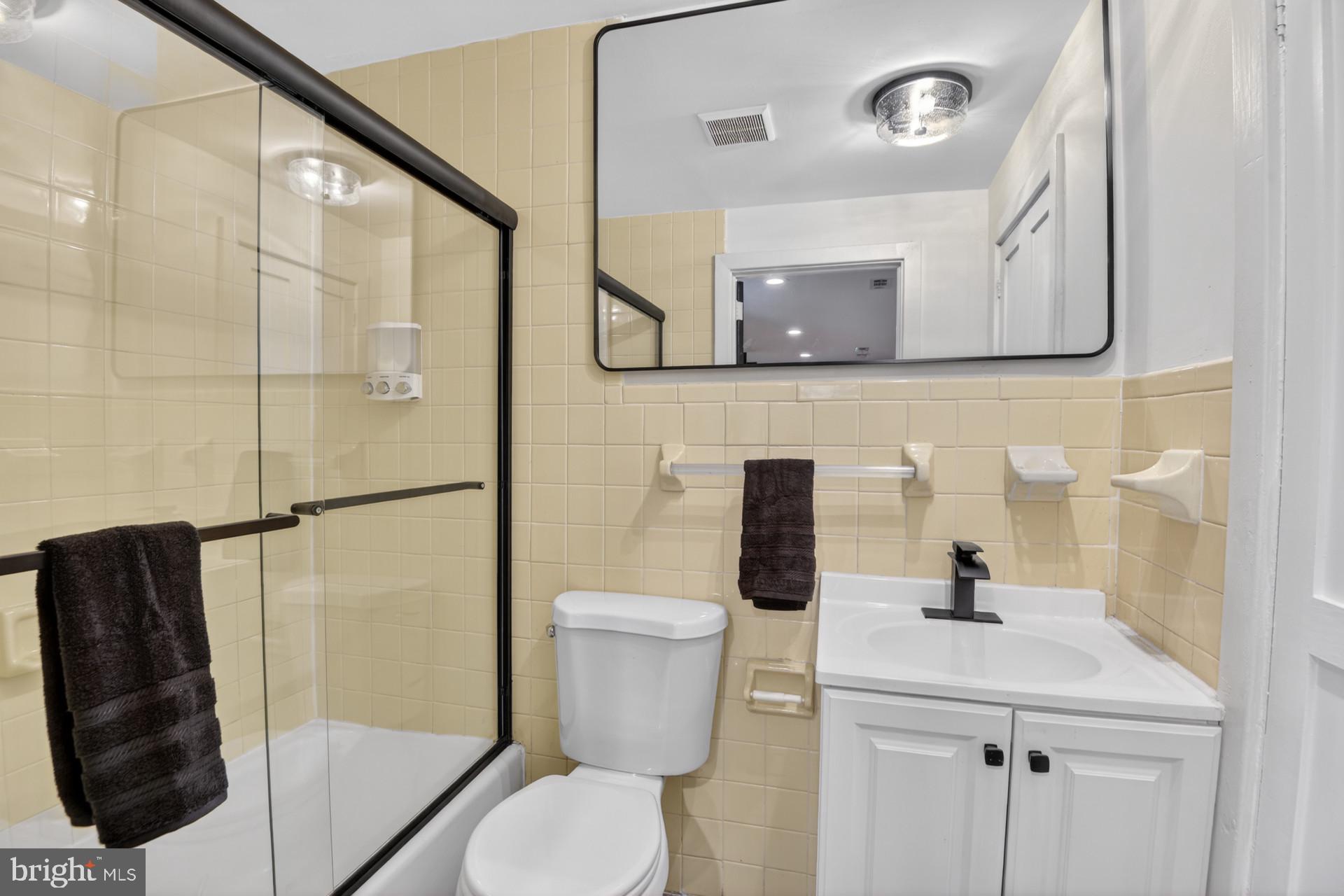 4416 Reno Road Northwest Washington, DC 20008 - Photo 30 of 39 a bathroom with a sink a toilet and shower