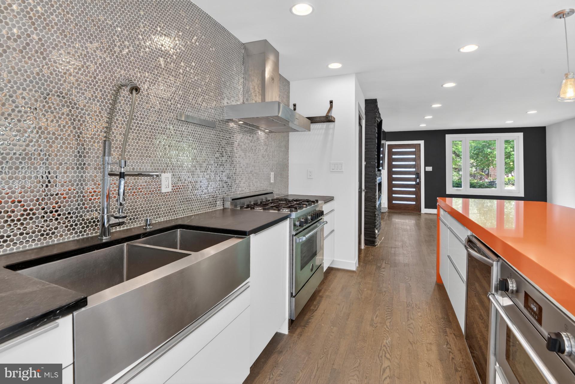 4416 Reno Road Northwest Washington, DC 20008 - Photo 3 of 39 a kitchen with stainless steel appliances a sink a stove and a refrigerator