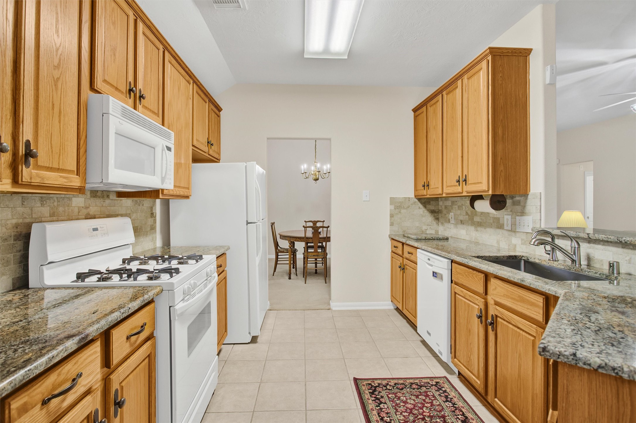 6031 Skyhaven Lane Spring, TX 77379 - Photo 7 of 33 Great kitchen with granite counters and tile backsplash.