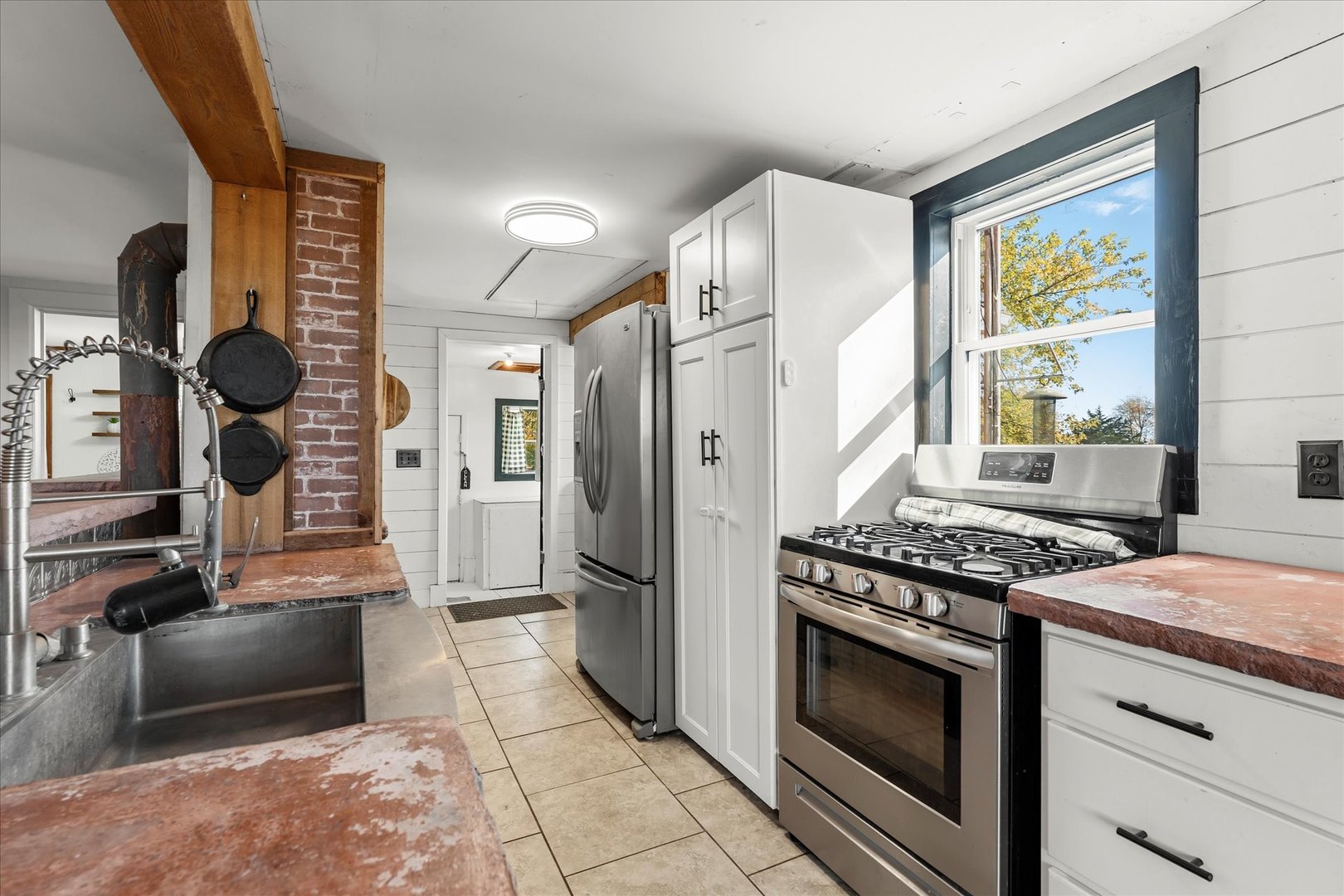 1311 East 4140 North Road Rankin, IL 60960 - Photo 23 of 54 a kitchen with a stove and a refrigerator