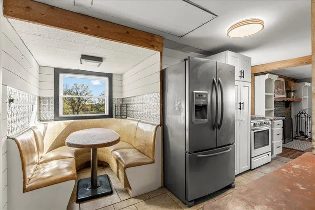 a view of a dining room with furniture and window