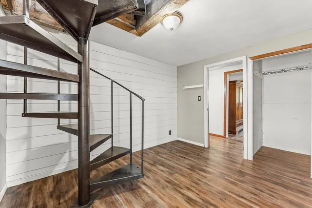 a view of entryway with stairs and wooden floor