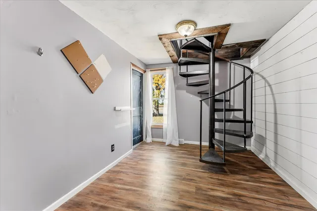 an empty room with windows and closet