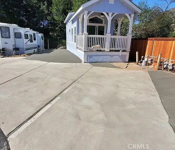 a view of a house with wooden fence