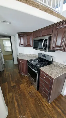 a kitchen with stainless steel appliances granite countertop a stove and a sink