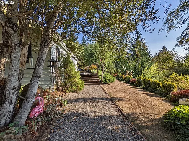 a backyard of a house with table and chairs