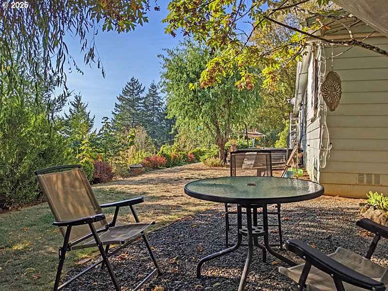 23999 Southwest Guenther Road Hillsboro, OR 97123 - Photo 6 of 16 a backyard of a house with table and chairs