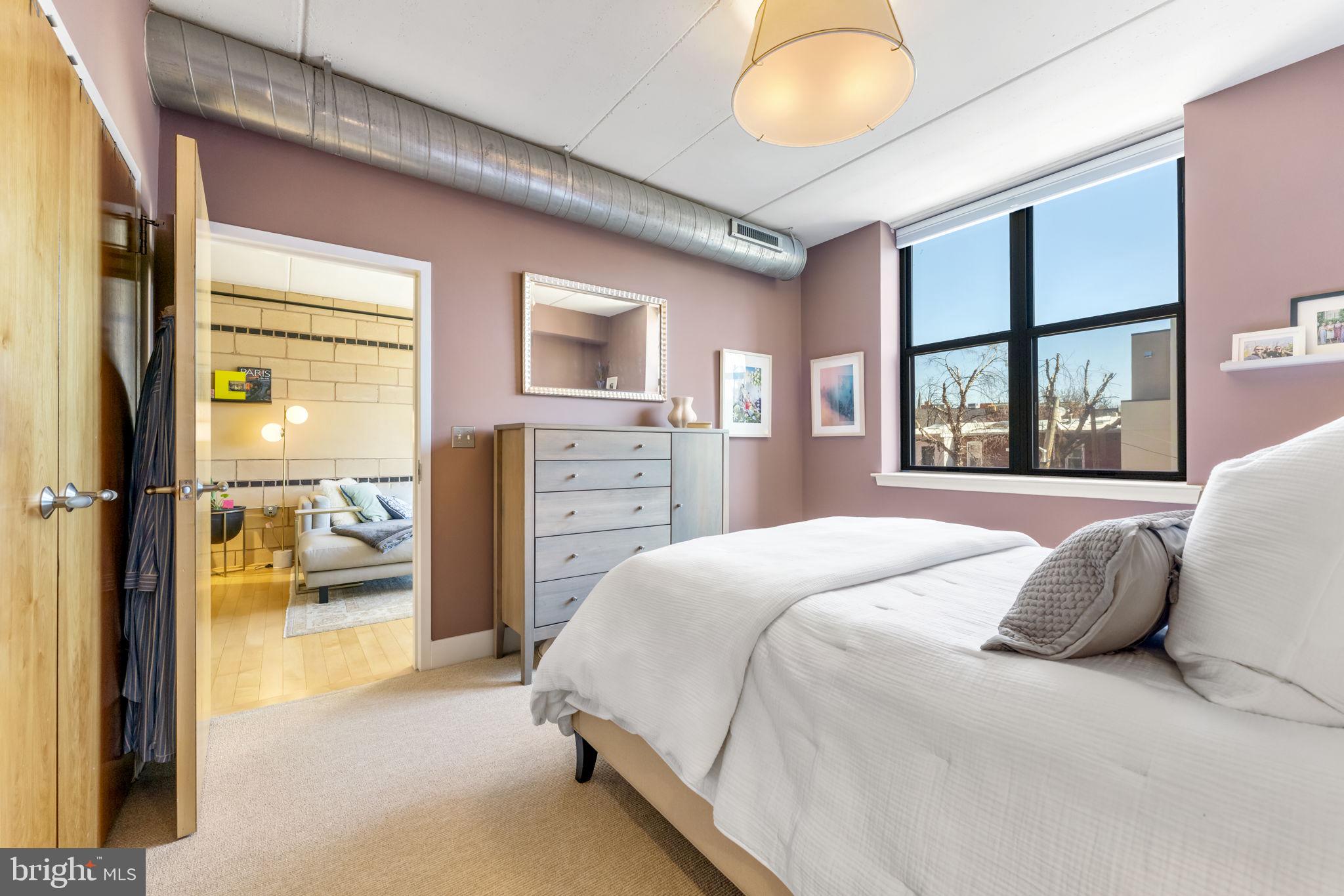 1529 14th Street Northwest, Unit 309 Washington, DC 20005 - Photo 11 of 21 a bedroom with a bed and a large window