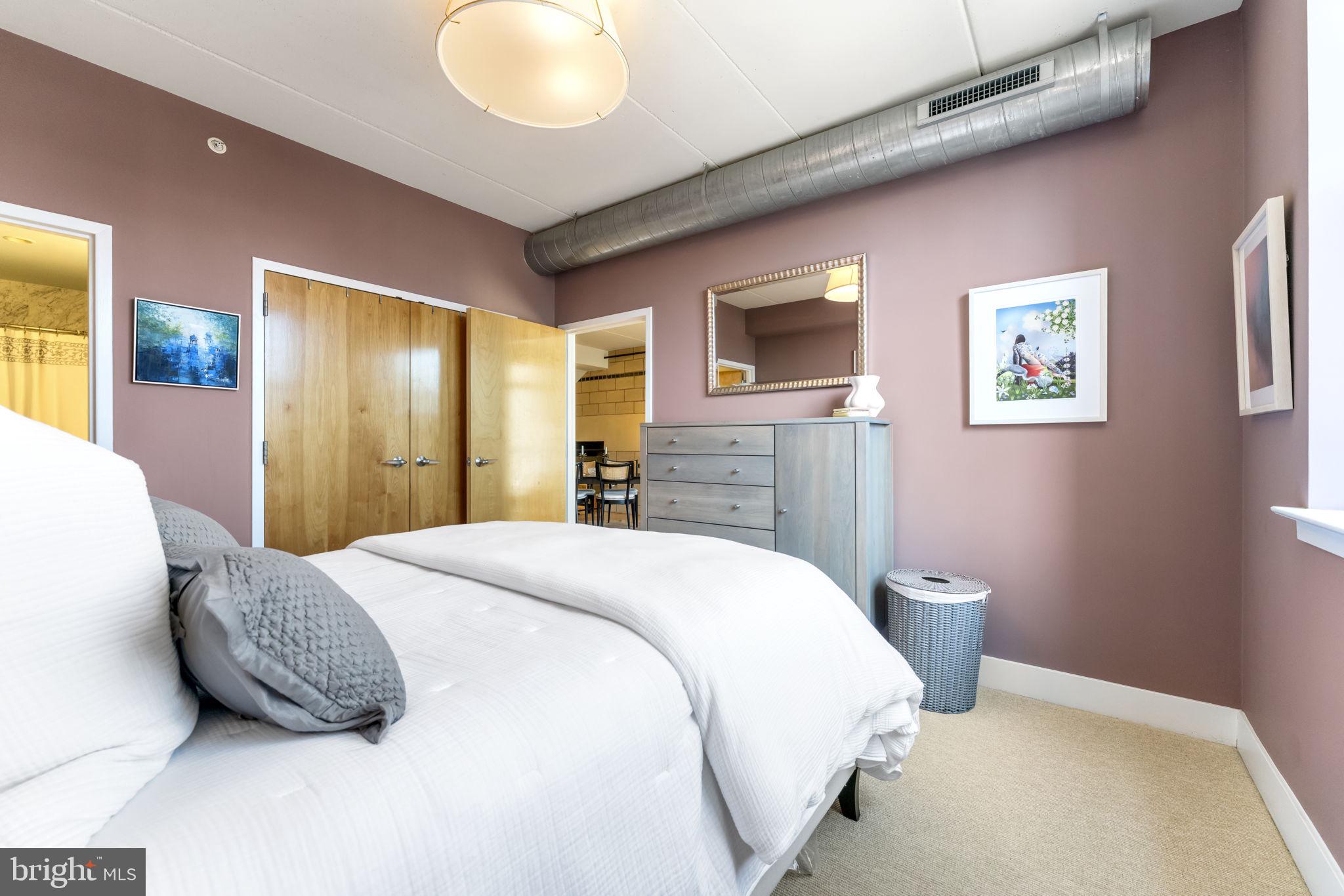 1529 14th Street Northwest, Unit 309 Washington, DC 20005 - Photo 12 of 21 a bedroom with a bed and a flat screen tv