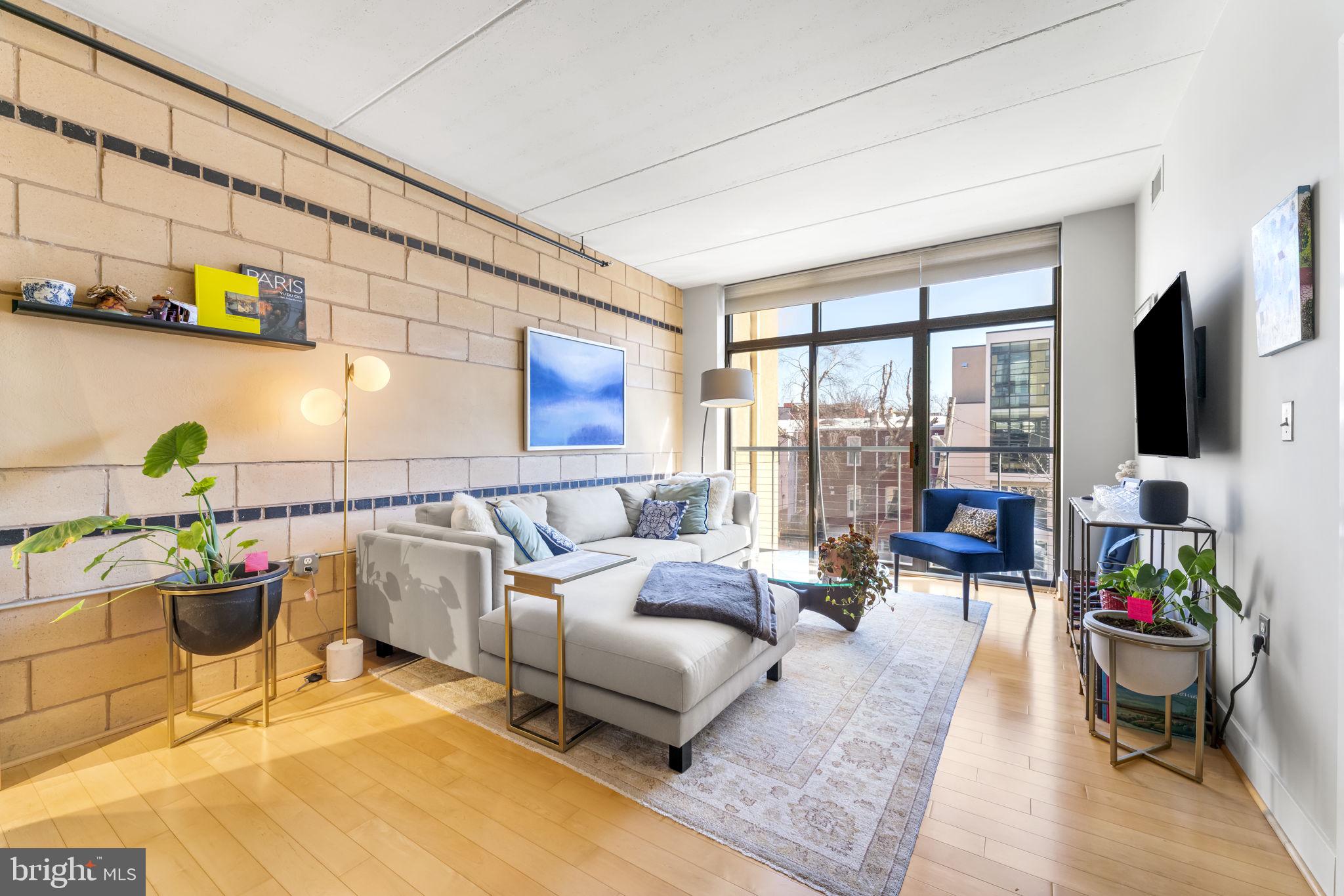 1529 14th Street Northwest, Unit 309 Washington, DC 20005 - Photo 3 of 21 a living room with furniture and a flat screen tv
