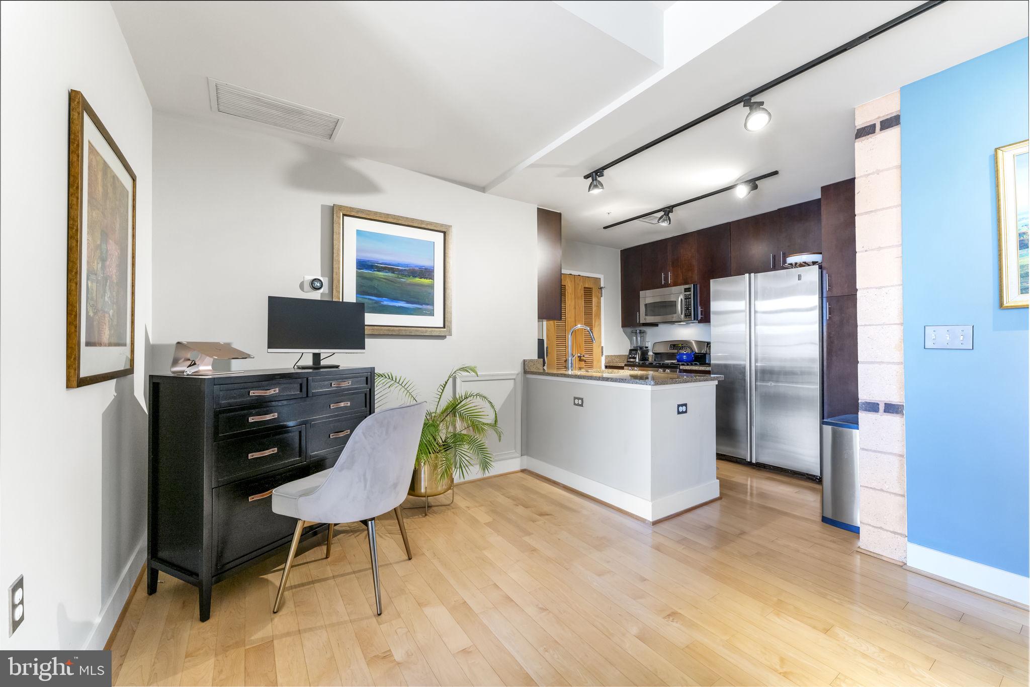 1529 14th Street Northwest, Unit 309 Washington, DC 20005 - Photo 5 of 21 a living room with stainless steel appliances furniture and a kitchen view