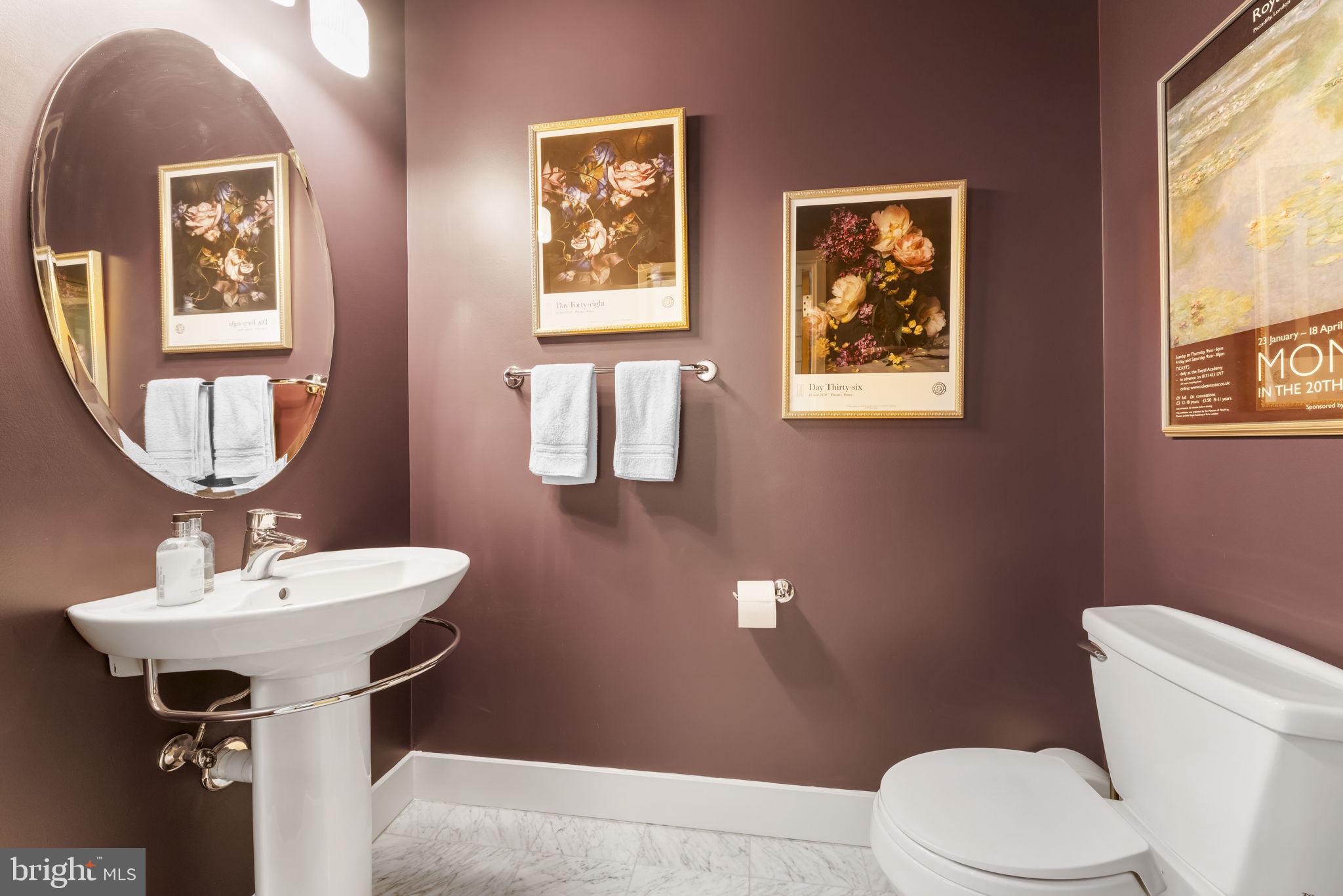 1529 14th Street Northwest, Unit 309 Washington, DC 20005 - Photo 8 of 21 a bathroom with a toilet sink and mirror